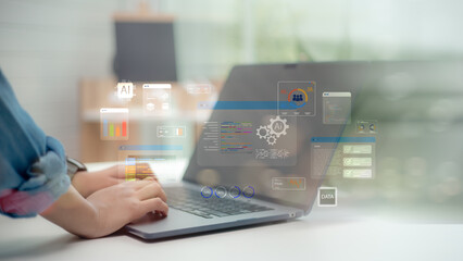 Hands typing on laptop with AI, data analytics, and machine learning icons, concept of artificial intelligence, digital transformation, and smart business technology innovation.