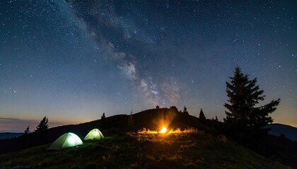 Obraz premium Campsite Under a Starry Sky on a Remote Hilltop