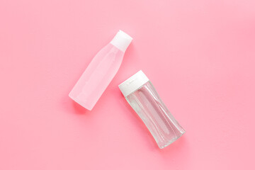 Organic cosmetics for face clearing with facial tonic and mycelial water on pink background top view copy space