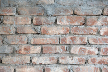 Aged red brick wall with cement texture background.