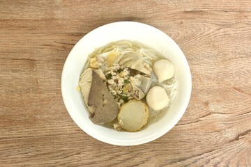 boiled vermicelli thin rice noodles topping pork ball and entrails with chop pork in clear soup on...