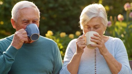 Senior couple enjoying beverages outdoors during the day - Powered by Adobe