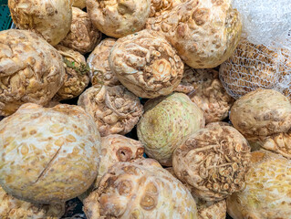 Fresh cauliflower heads displaying natural white and cream colors arranged in abundant market produce display setting. high quality photograph