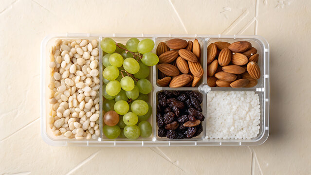 Healthy snack tray featuring grapes nuts and dried fruit for a nutritious treat