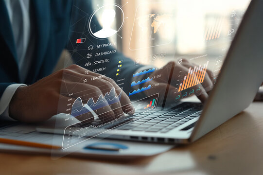 Professional hands typing on laptop with data visualization graphics showcasing statistics, analytics, and business insights in modern workspace environment