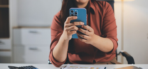 Closeup image of a businesswoman using mobile phone in office