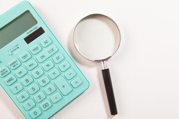 calculator with coins on a white background