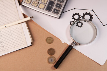 magnifying glass, calculator, magnifier on wooden table, flat lay with text for business