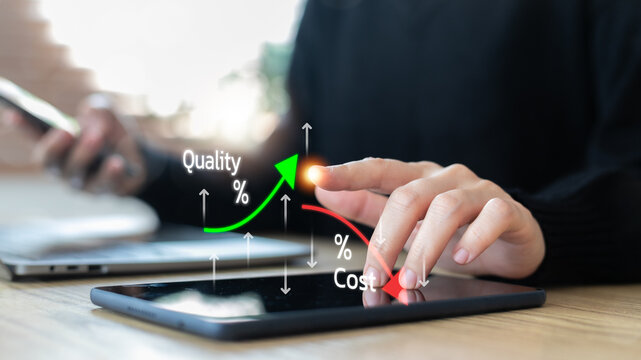 Business concept with a hand using a tablet showing cost reduction and quality improvement graph, technology for efficiency, finance and digital strategy.