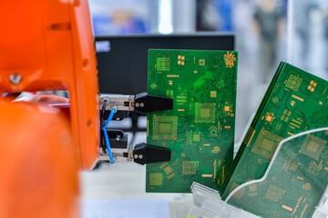 Modern Robot Arm automation system moving circuit boards in a factory ,industrial robot concept