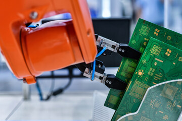Modern Robot Arm automation system moving circuit boards in a factory ,industrial robot concept