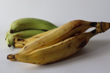 Raw and ripe Nendran plantains in bunches, showing ripening stages. Good for harvest and food themes