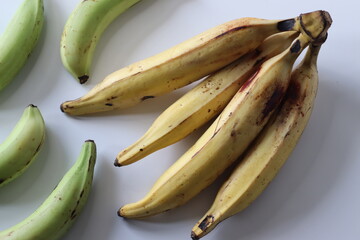 Raw and ripe Nendran plantains in bunches, showing ripening stages. Good for harvest and food themes