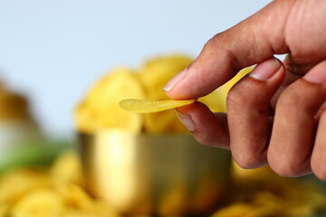 Hand held banana chip, thin and crisp. South Indian snack from Kerala, perfect for snacking themes