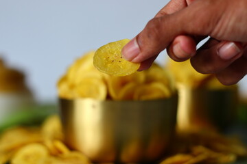 Hand held banana chip, thin and crisp. South Indian snack from Kerala, perfect for snacking themes