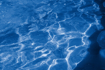 dark blue water surface with gentle ripples, perfect natural background or texture for design