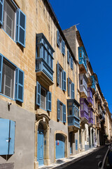 A street in Valletta with many colorful traditional balconies