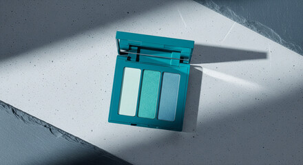 Teal Eyeshadow Compact on Minimalist Blue Concrete Surface, Soft Natural Light, Ample Copy Space for Beauty and Wellness Brands