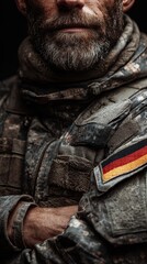Military soldier in camouflage uniform showcasing German flag patch during training in a wooded area at sunset