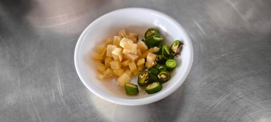 Sliced ??chilli and ginger in a white bowl