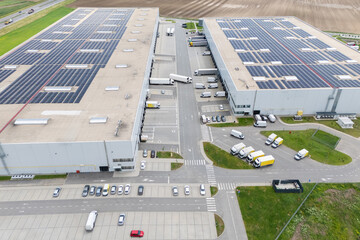 Logistic center with solar panels on roof. Aerial view