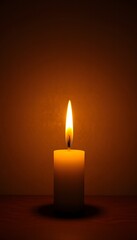 Glowing candle on dark wood illuminates serenity and warm mood