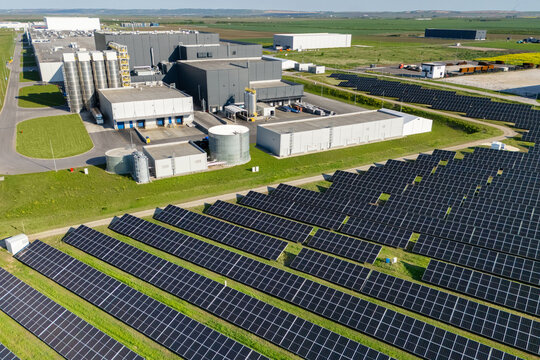 Modern green factory powered by renewable solar energy. Sustainable development in industry
