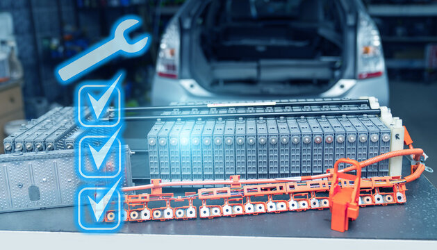 Repairing electric battery pack of hybrid car - Powered by Adobe