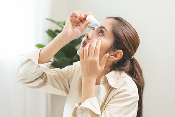 Health care concept, eye problem asian young woman applying, using medical eye drops to treat dry...