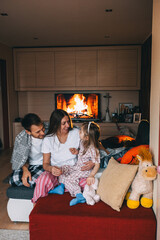 Cozy family gathering by the fireplace in a modern living room during winter evenings