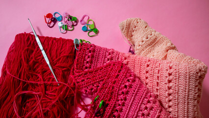Crochet yarn with red gradation, crochet hook, crochet marker