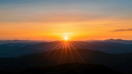 The sun is setting over a mountain range, casting a warm glow over the landscape