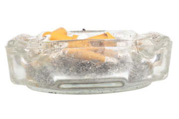 A glass ashtray with extinguished cigarette butts inside on a white background
