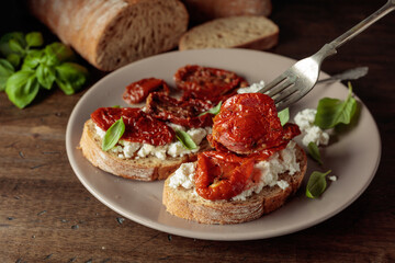 Ciabatta with sun dried tomatoes in olive oil, ricotta, and basil.