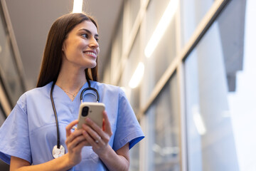 Fototapeta premium Confident medical professional using mobile phone technology in modern healthcare setting, showcasing efficiency and connectivity