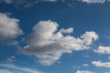 White clouds against blue sky on clear sunny day
