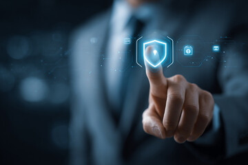 Businessman touching a digital shield icon for cybersecurity protection