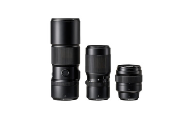 Three black camera lenses of varying sizes in a studio shot