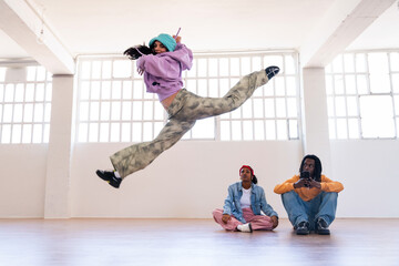 Naklejka na ściany i meble Young group of multiethnic hip-hop dancers dancing