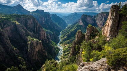 Fototapeta premium High-angle view of a deep canyon with a river winding through