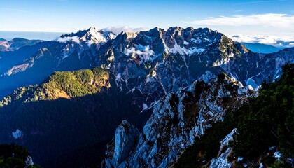 A breathtaking vista of a mountain range, showcasing rugged peaks, lush forests, and patches of snow, bathed in the warm morning light.