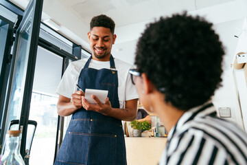 Barista working in a bar cafeteria