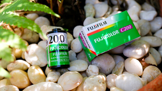 Rayong, Thailand Aug 24, 2025 - Vintage 35mm film roll and box placed on natural stone background, classic Fujicolor C200 photography film for analog cameras