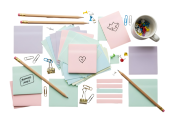 Flat lay of stationery items including notebooks, pencils, paper clips, push pins, and a mug filled with push pins on a white background