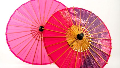 Two vibrant, traditional Japanese paper umbrellas, showcasing intricate patterns and a gradient of pink and purple hues, sit against a stark white backdrop.