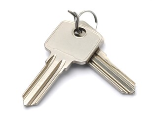 Two silver house keys on a white background
