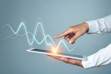 Hand using a tablet to analyze data with glowing graph overlay