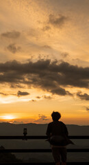 Man enjoying the beautiful sunset over a valley