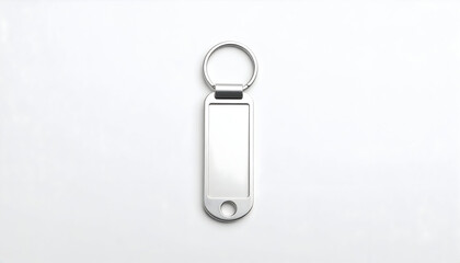 Minimalist silver metal keychain mockup with a blank rectangular fob and split ring, presented in a clean top-down view on a white background.