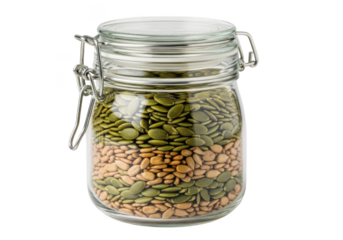 Glass jar with layered pumpkin and sunflower seeds on background container metal